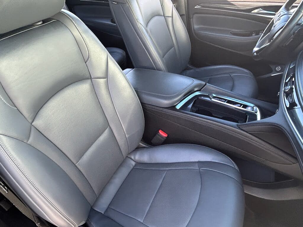 10 Interior of a car featuring gray leather front seats and a center console.