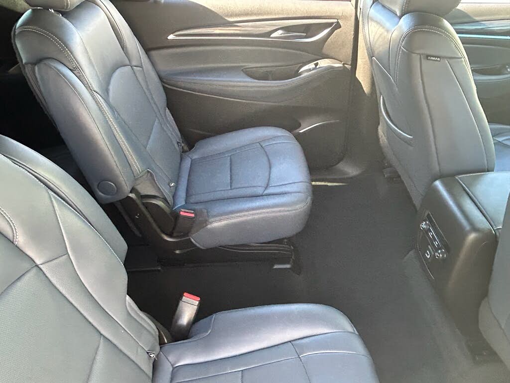 15 Interior of a car with gray leather seats, featuring two rear captain chairs.