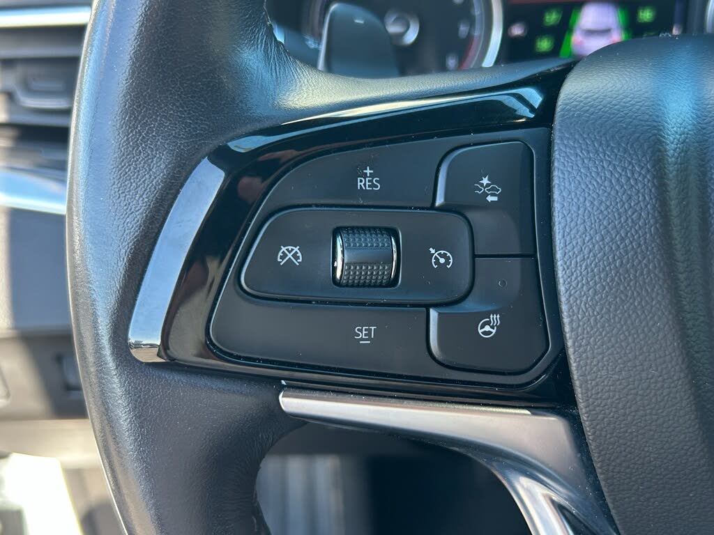 24 Close-up of a car steering wheel with cruise control buttons, including RES and SET.
