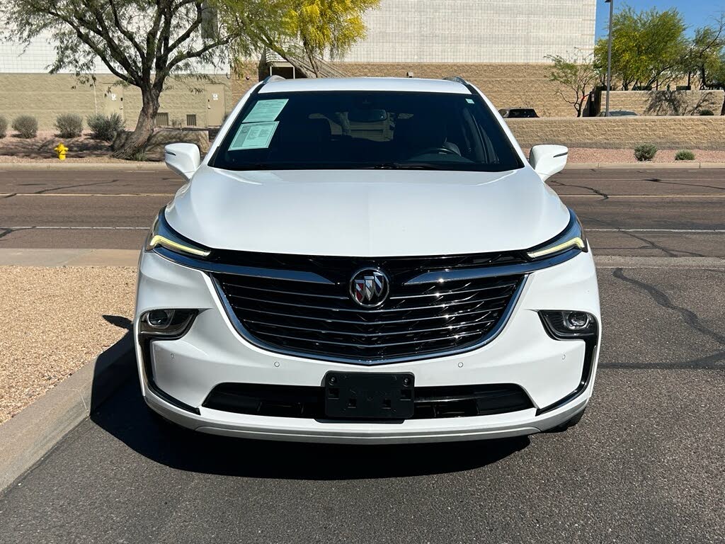 8 Front view of a white Buick SUV parked on a paved street.
